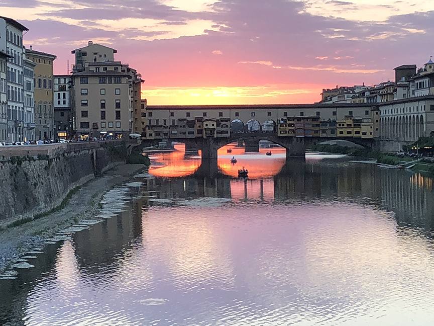 The Ponte Vecchio at sunset reflected in the Arno